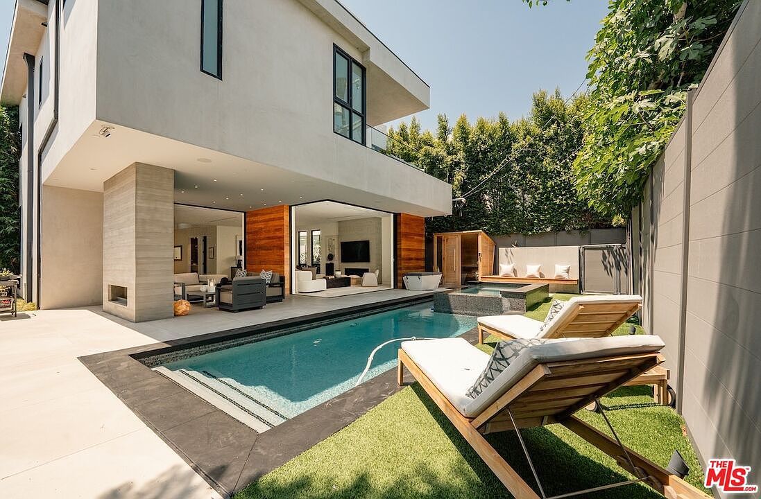 Architectural backyard with pool, spa, and retractable glass walls onto the great room.
